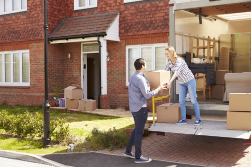 Professional movers navigating stairs in a Notting Hill property