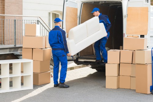 Professional house removalists unloading belongings at a new home