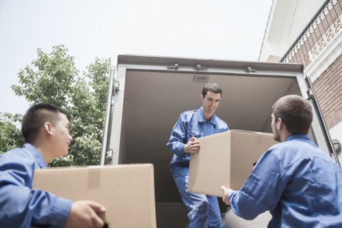 Professional commercial movers handling office equipment