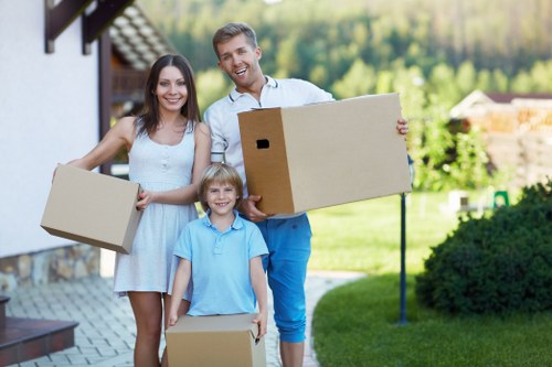 Local movers handling household items near apartment access