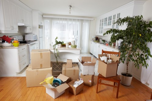 Packed boxes and furniture ready for collection by removal van