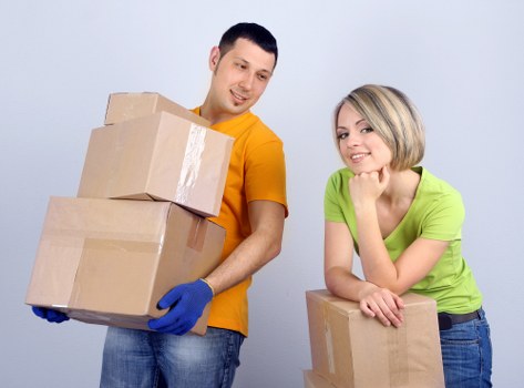 Student packing checklist beside moving boxes in a Notting Hill home