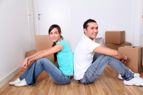House removal service in Nottinghill carefully carrying furniture through a home