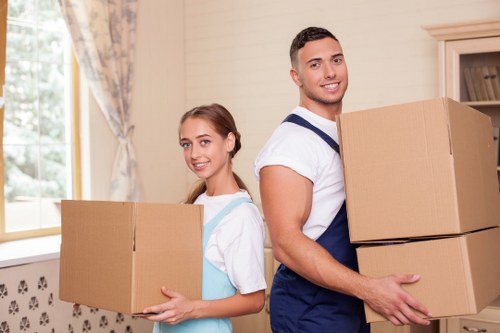 Packed boxes and furniture ready for loading into a moving truck in Notting Hill